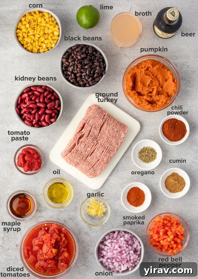 A vibrant flat lay of all the fresh and canned ingredients required for making a delicious pumpkin chili, including pumpkin puree, beans, vegetables, and spices.