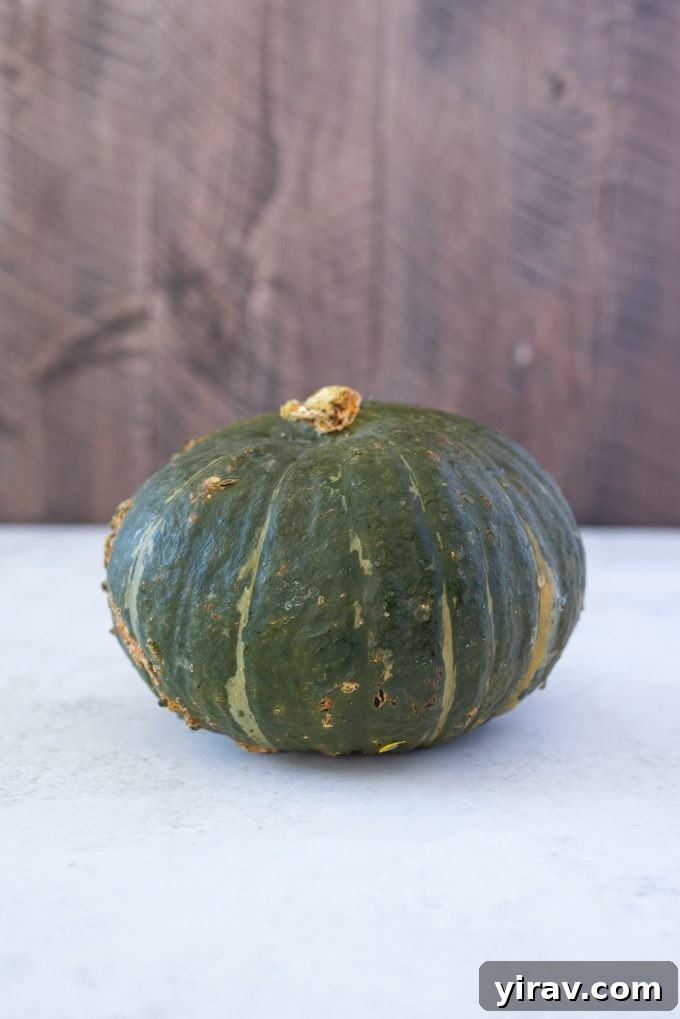 Whole Kabocha squash on a wooden surface