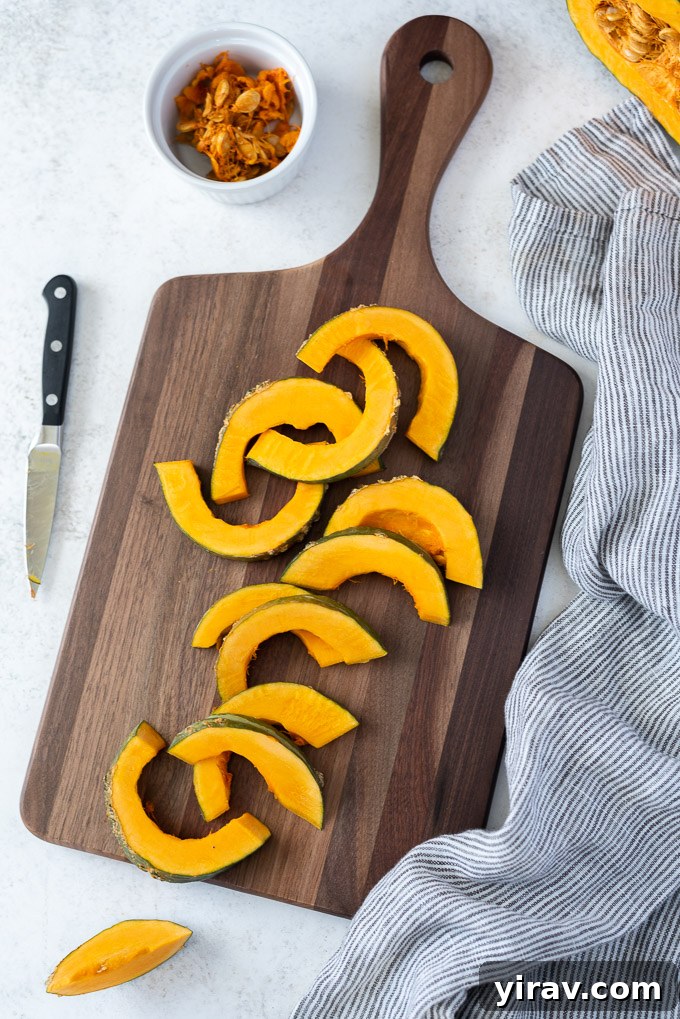 Slices of kabocha squash on a cutting board, ready for cooking