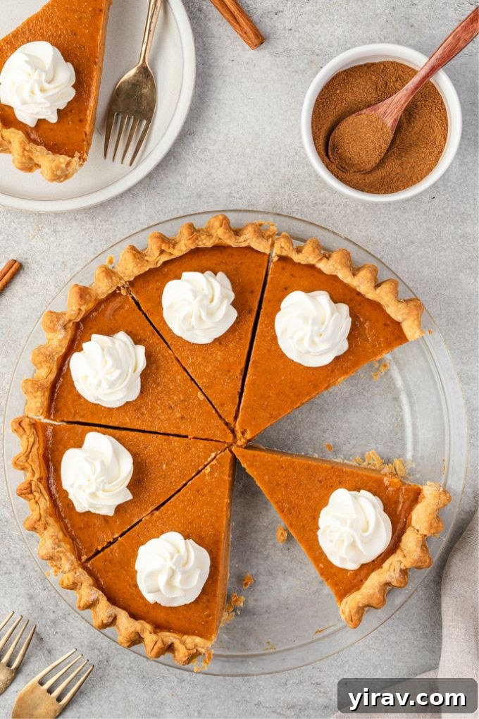 Perfect Homemade Pumpkin Pie 3 Whole homemade pumpkin pie in a baking dish, sliced, with dollops of whipped cream on top