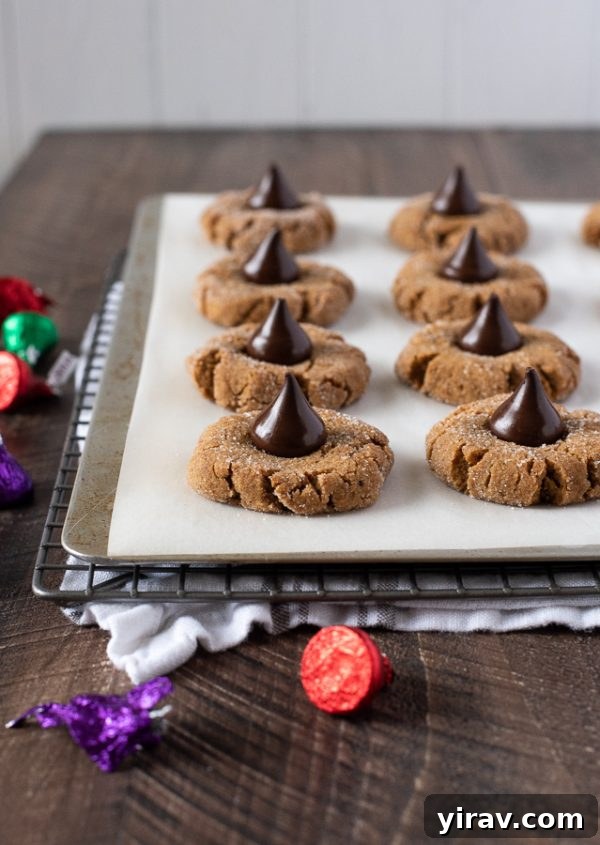 Gluten-free peanut butter blossoms arranged on a baking sheet