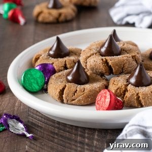 Gluten free peanut butter blossoms on white plate with kisses
