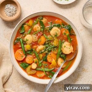 A bowl of Instant Pot Vegetable Soup, garnished with parsley and black pepper, ready to be served.