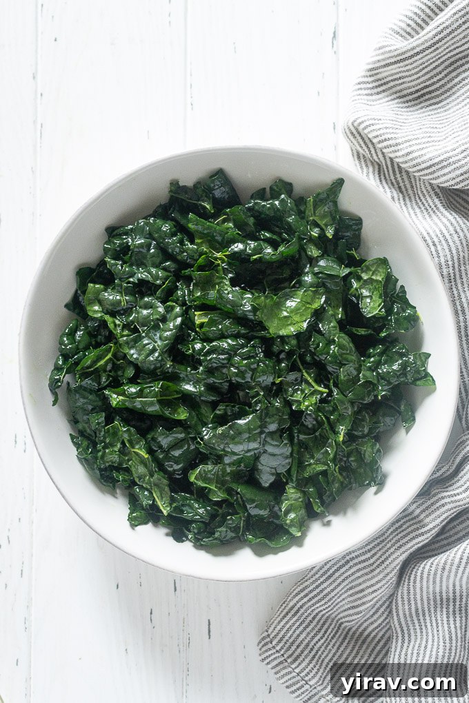 Silky Kale Salad 5 Close-up of massaged kale in a pristine white bowl, showcasing its tender texture after preparation.