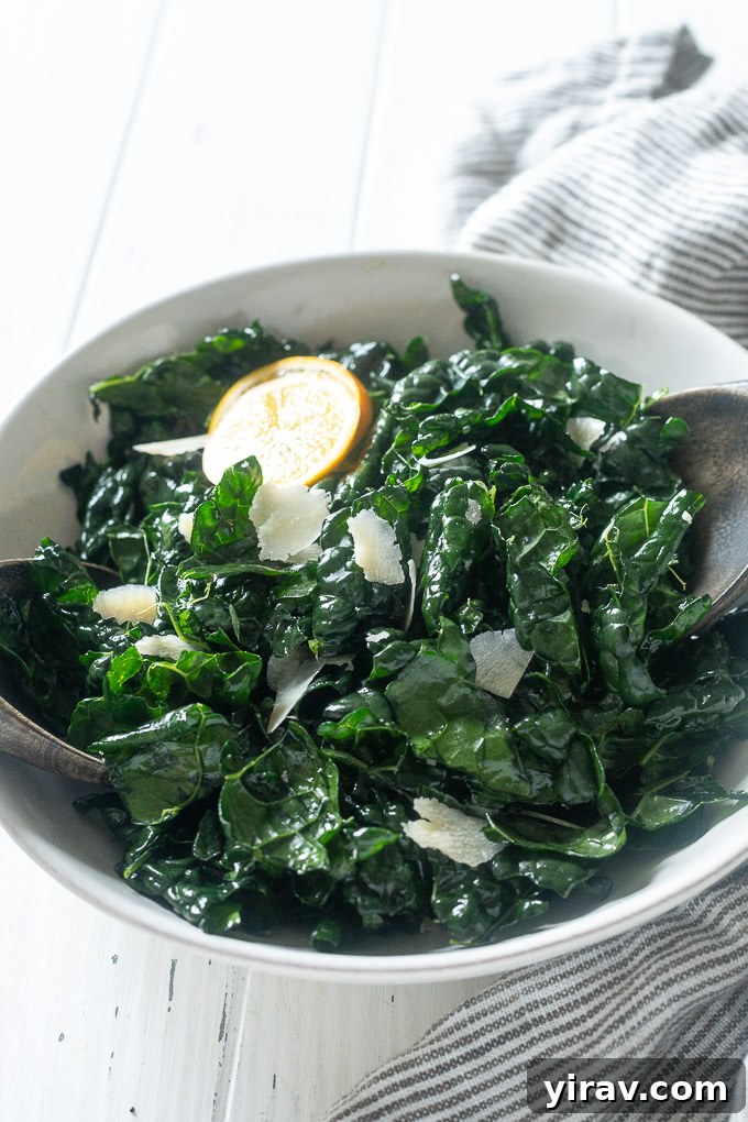 Silky Kale Salad 6 Massaged kale salad presented in a large serving bowl with wooden salad servers, ready to be enjoyed.