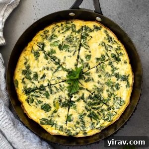 Spinach frittata in a skillet cut into slices