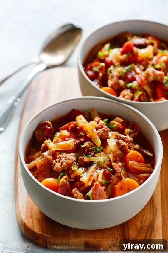 Two cozy bowls of hearty Cabbage and Sausage Stew, rich with nutritious ingredients.