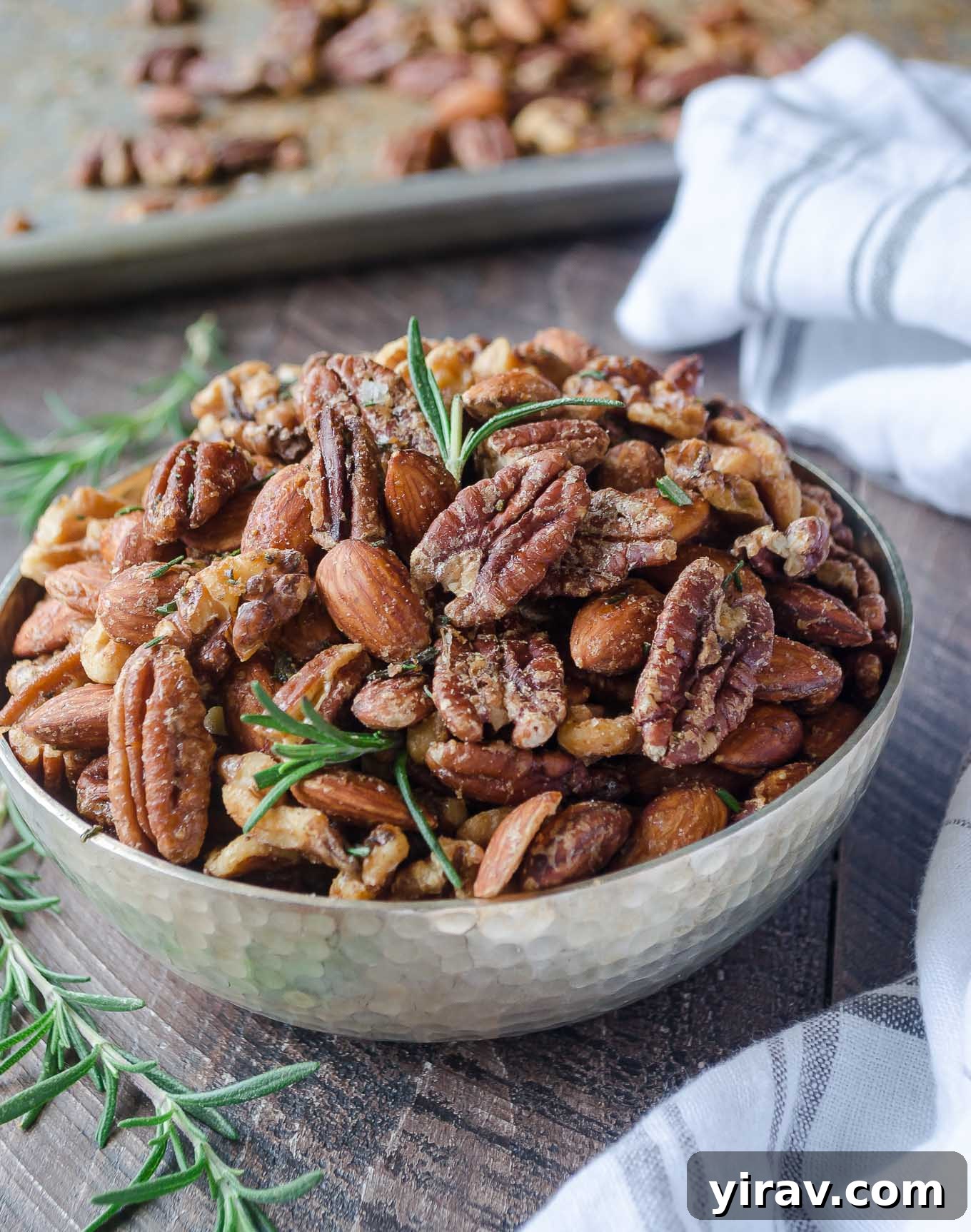 Roasted nuts in a bowl with rosemary