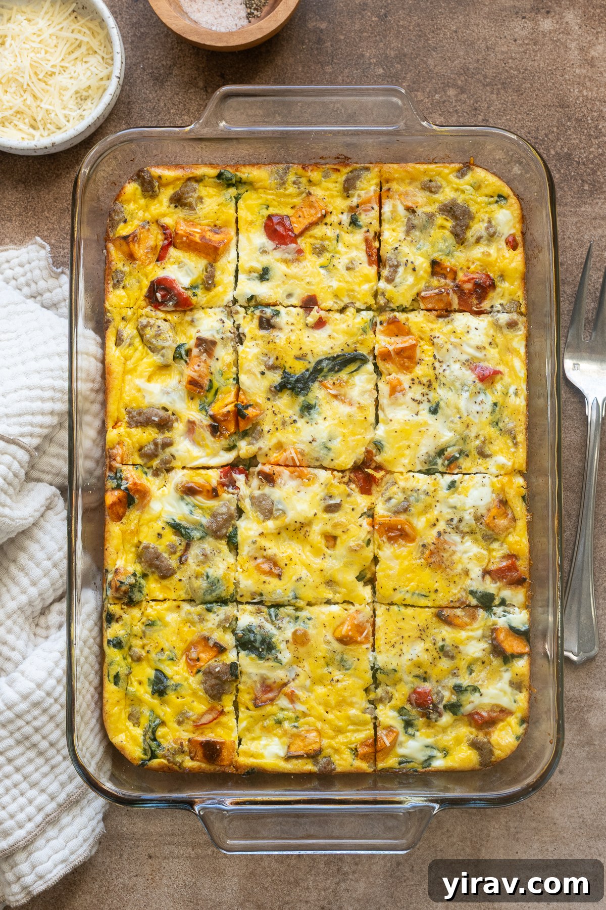 Sausage and egg breakfast casserole sliced in baking dish.