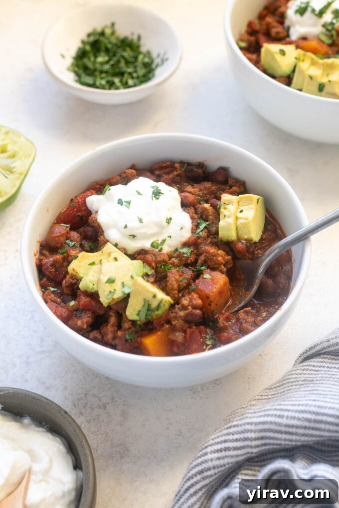 Hearty Butternut Turkey Chili 2 A steaming bowl of Butternut Squash Turkey Chili, garnished with fresh cilantro and a dollop of sour cream.