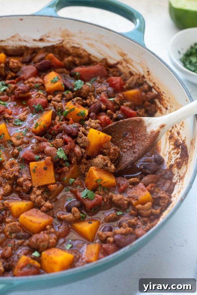 Hearty Butternut Turkey Chili 3 Butternut Squash Turkey Chili simmering in a large Dutch oven, showing the rich texture and vibrant colors.