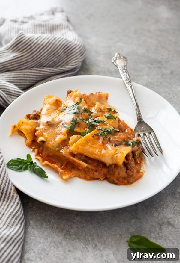 A generous serving of skillet lasagna on a plate with fresh basil, showcasing a quick and comforting dinner option