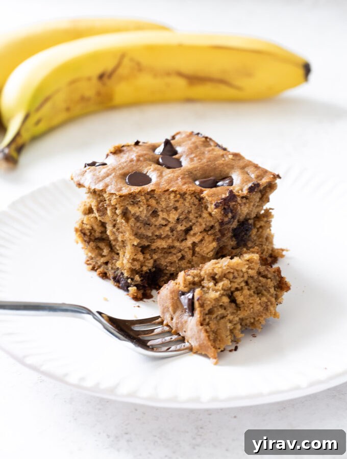 Golden Banana Bites 2 Slice of healthy banana snack cake on a plate, showcasing its tender texture.