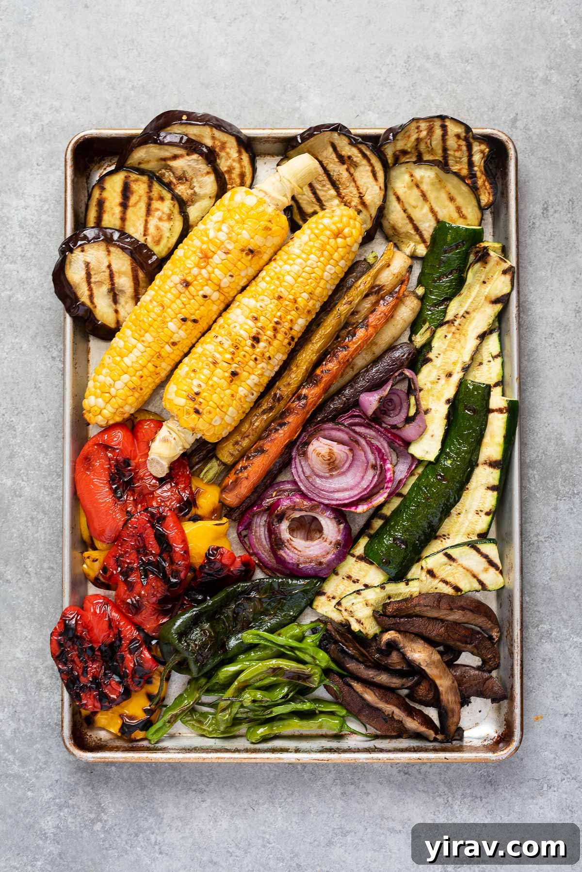 Rimmed baking sheet filled with grilled vegetables