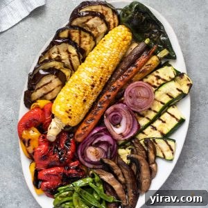 Grilled vegetables arranged on a white serving platter