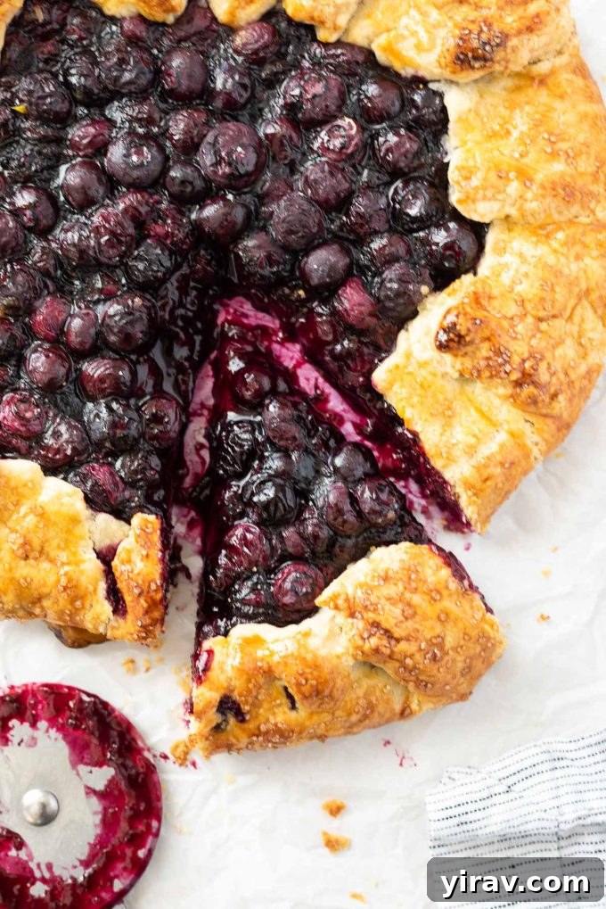 Blueberry galette with slice cut.