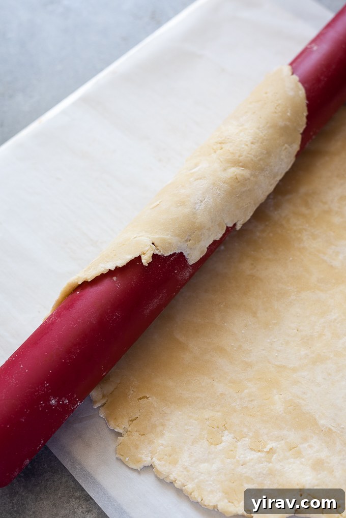 Roll the galette dough around a rolling pin and place on a baking sheet.