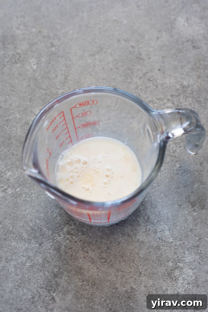 Milk and vinegar combined in a measuring cup for galette dough.