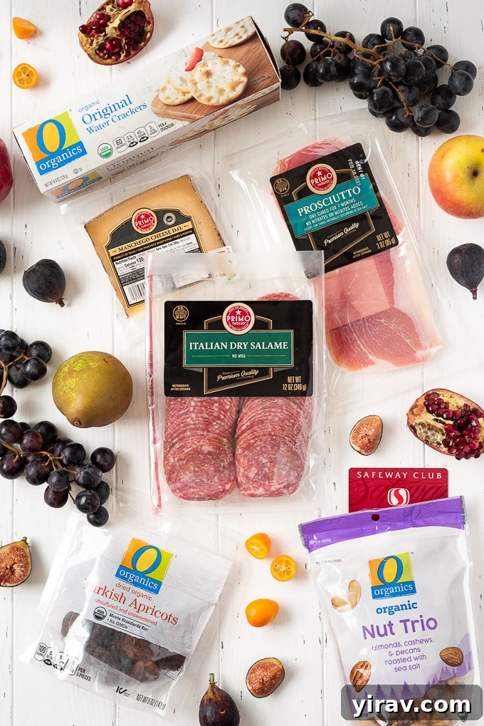 A flat lay photograph showcasing all the individual ingredients needed to assemble a beautiful fall charcuterie board, including cheeses, meats, various crackers, fresh fall fruits, nuts, and condiments.