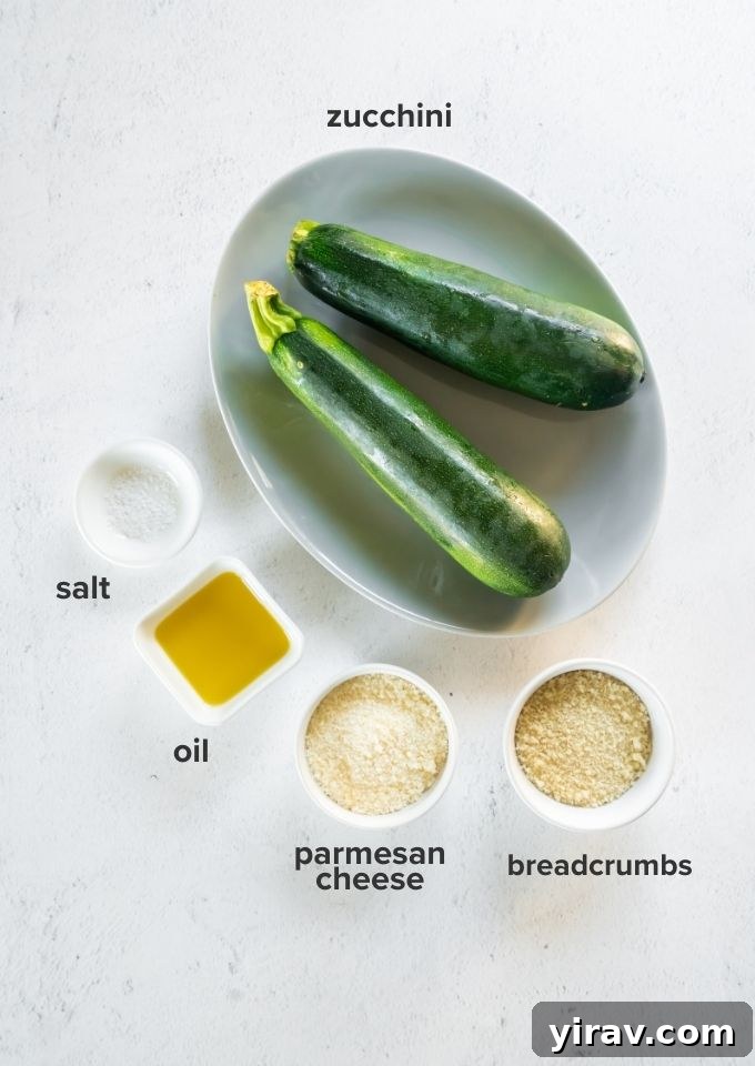 Oven Baked Zucchini Crisps 4 Close-up of fresh zucchini, olive oil, panko breadcrumbs, and grated parmesan cheese – the simple ingredients for baked zucchini chips.