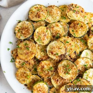 Oven Baked Zucchini Crisps 8 Baked zucchini chips on a serving plate