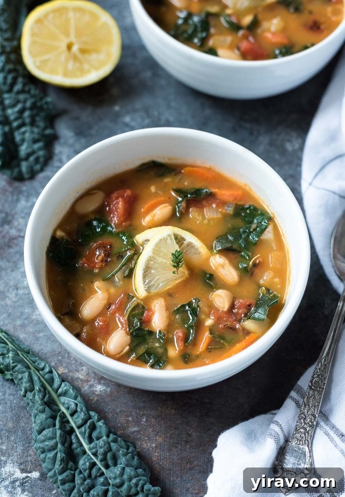 White bean and kale soup in a bowl with lemon and thyme