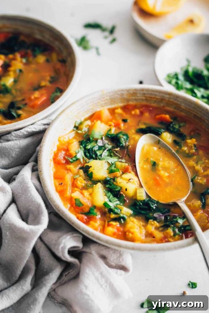 Vegan red lentil soup in a bowl with a spoon