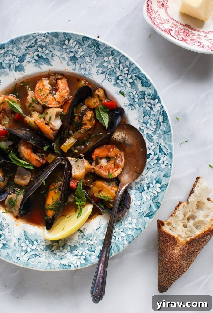 Cioppino in a bowl with crusty bread