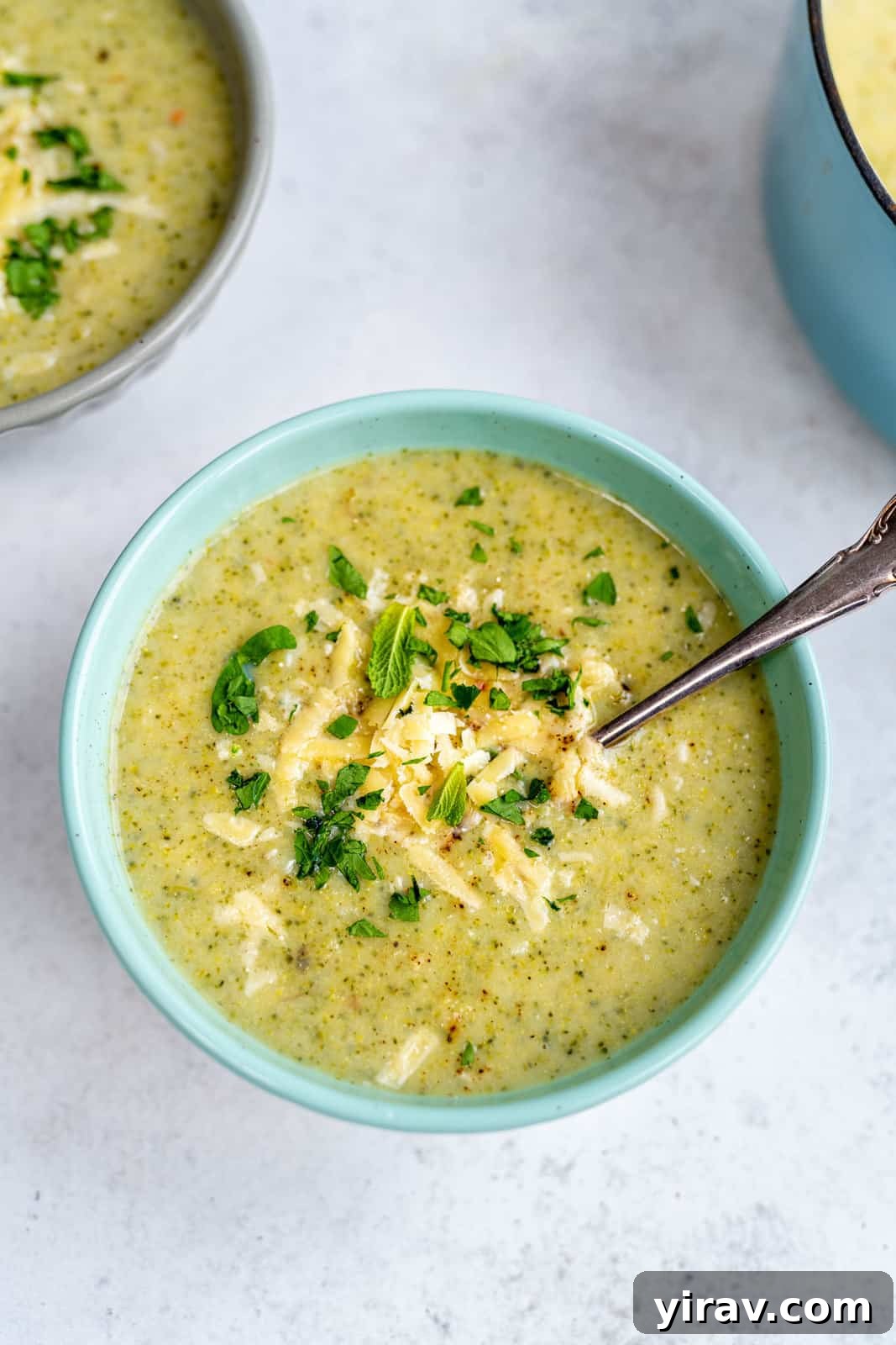 Broccoli soup in a bowl with spoon