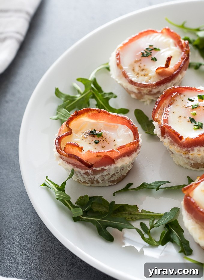 Individual bacon and egg cups arranged on a platter, ready to be served for a delightful breakfast.