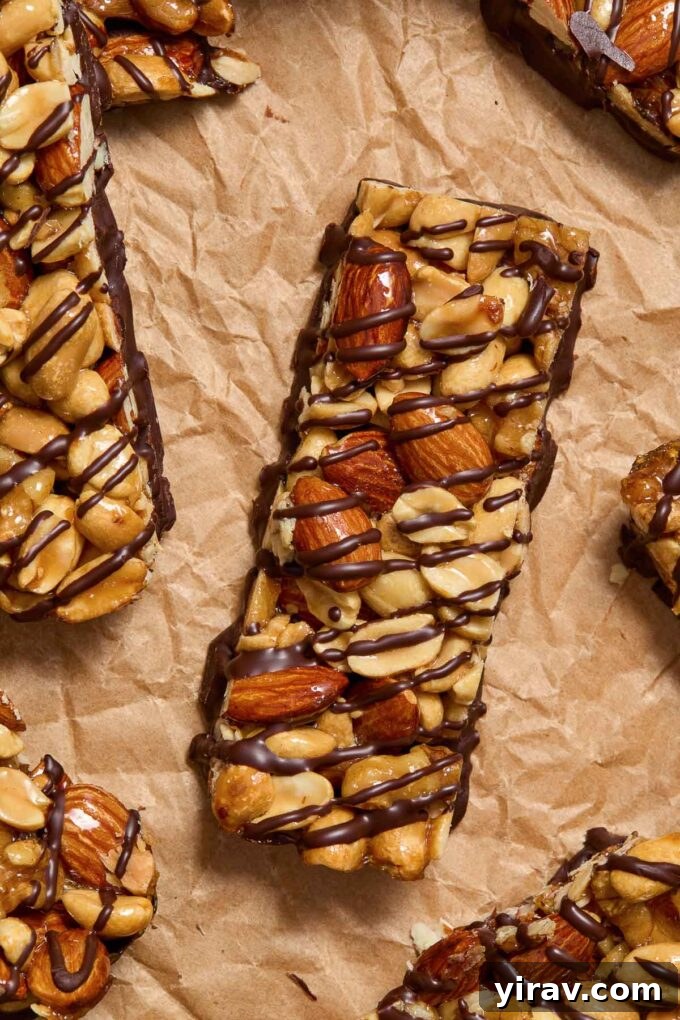 A close-up of homemade KIND bars, elegantly drizzled with dark chocolate, showcasing their rich texture.