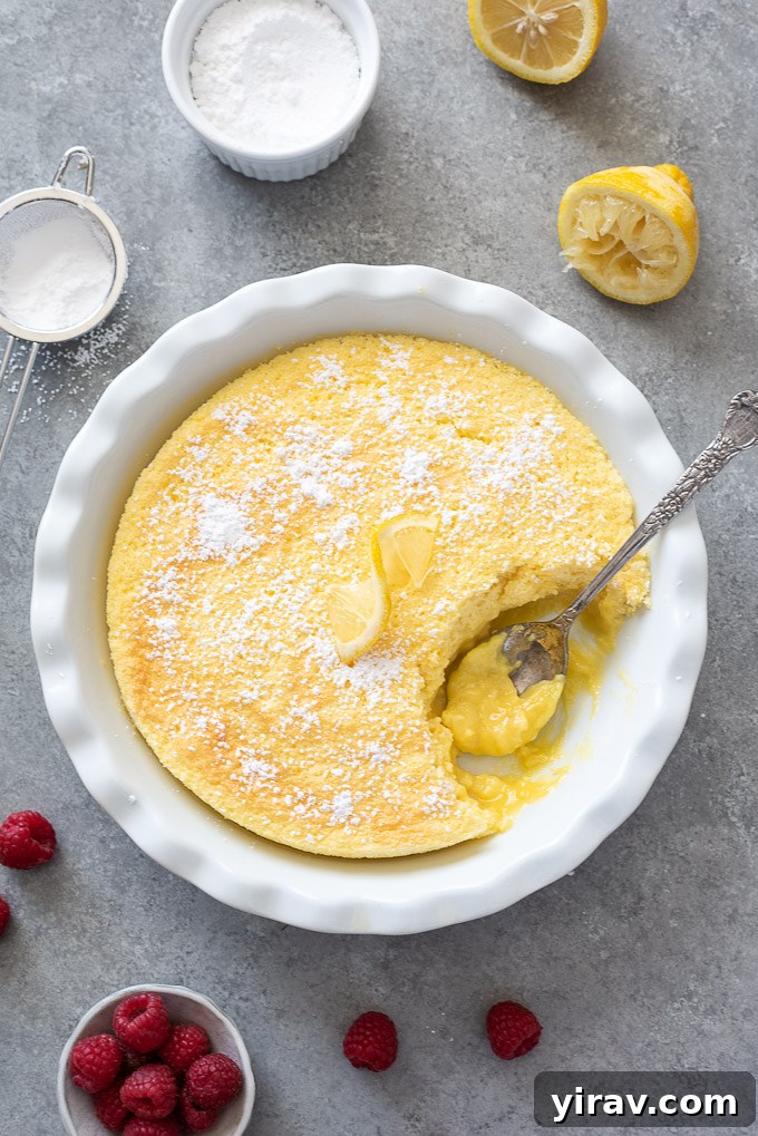 Magic Lemon Pudding Cake 8 Spoon digging into lemon pudding cake