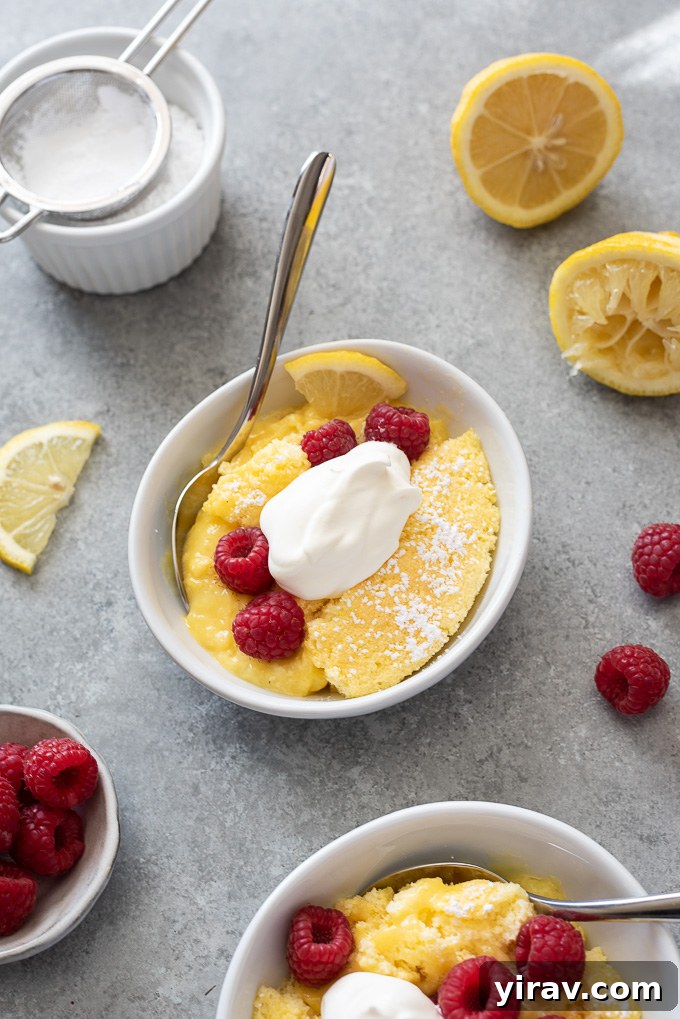 Magic Lemon Pudding Cake 9 Serving of lemon pudding cake in a bowl with whipped cream and berries