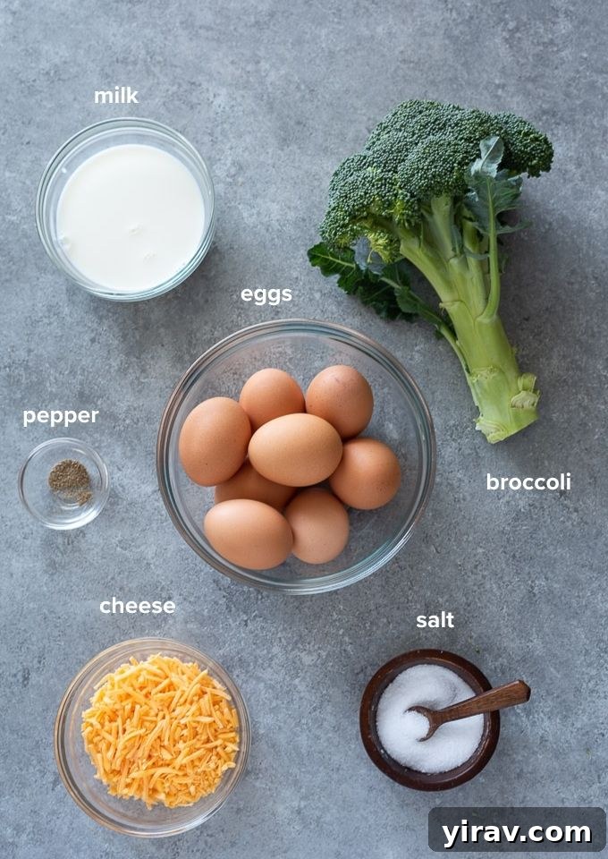 Fresh ingredients for crustless broccoli quiche, including whole eggs, vibrant green broccoli florets, creamy cheddar cheese, and a bottle of milk, arranged invitingly on a kitchen counter.