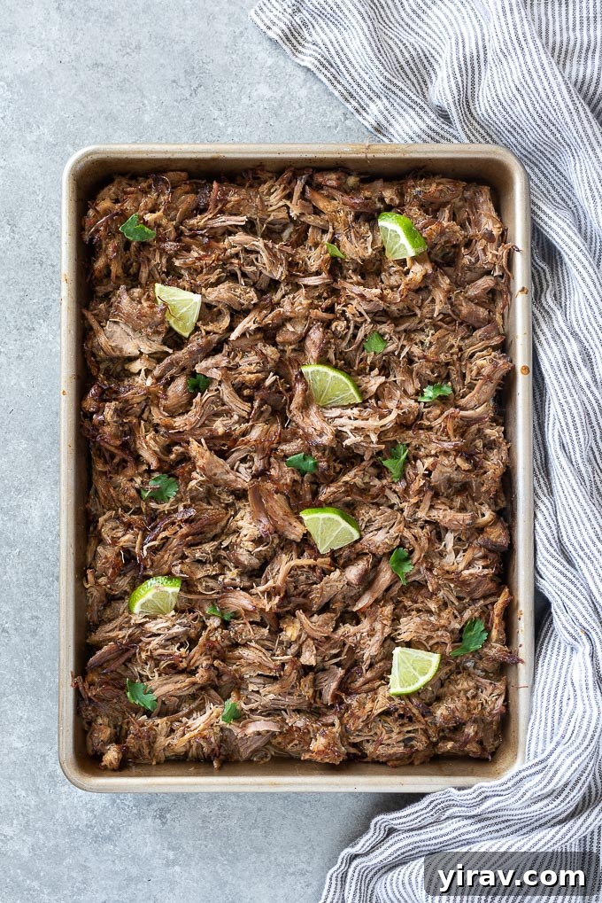 Baking sheet with shredded pork carnitas, lime and cilantro