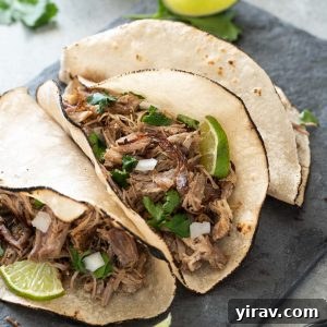 Slow Cooker Pork Carnitas in tortillas with onion, cilantro and lime