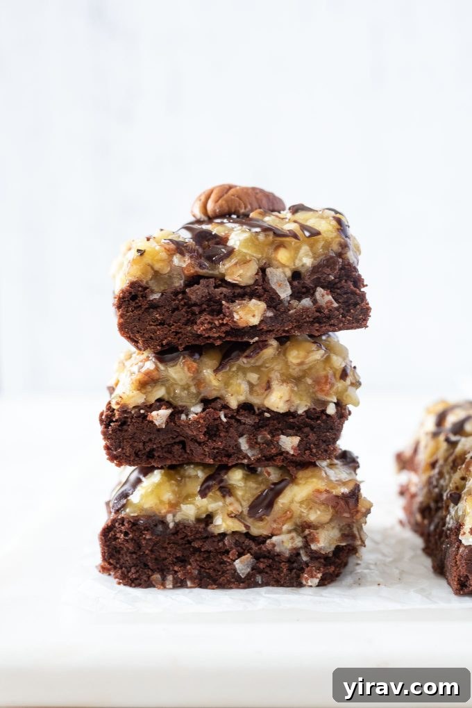 German Chocolate Cake Brownies 2 Stack of rich, fudgy German chocolate brownies topped with coconut pecan frosting and chocolate ganache