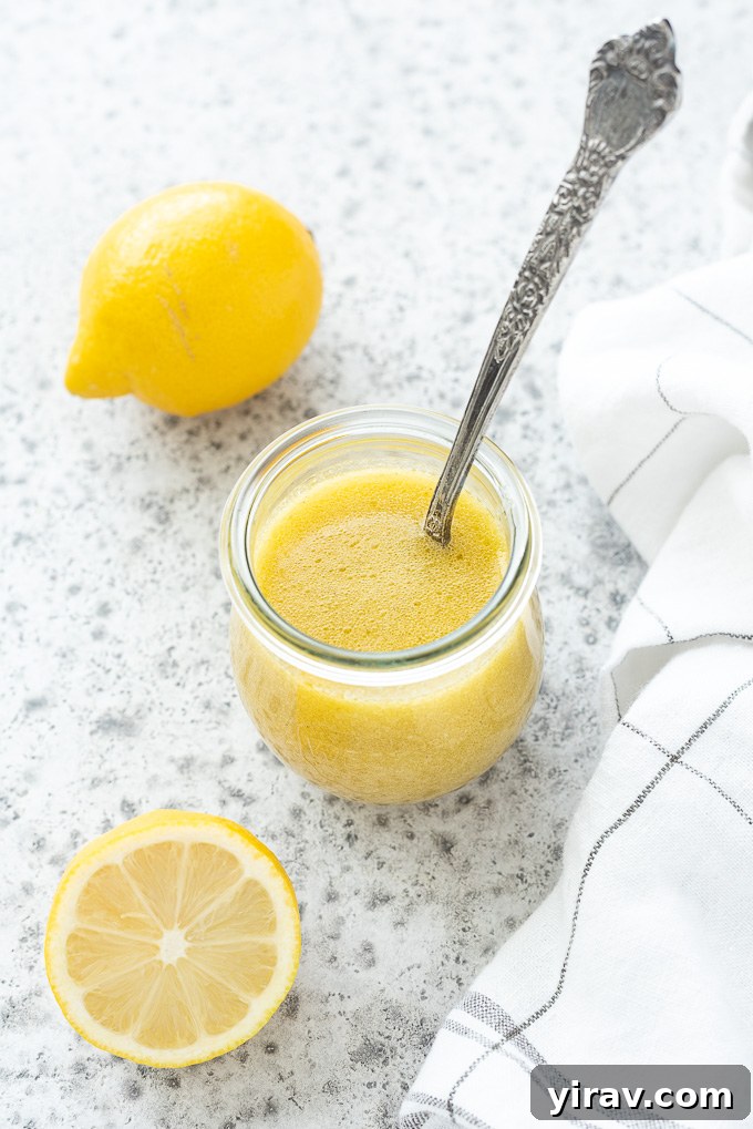 Zesty Lemon Vinaigrette 3 Spoon in a jar of lemon vinaigrette