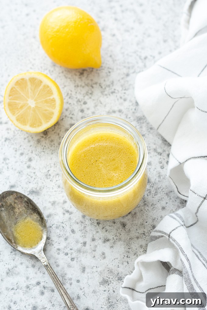 Zesty Lemon Vinaigrette 6 Lemon salad dressing in a jar with lemons and a spoon