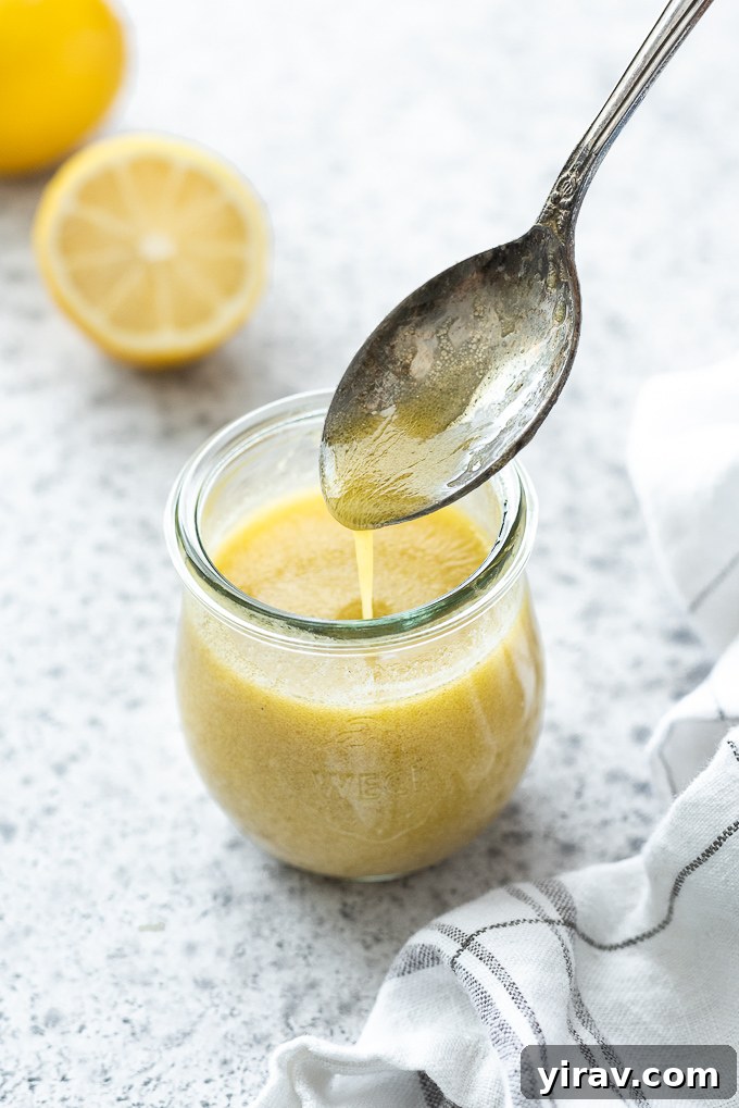 Zesty Lemon Vinaigrette 7 Lemon vinaigrette drizzling off of a spoon