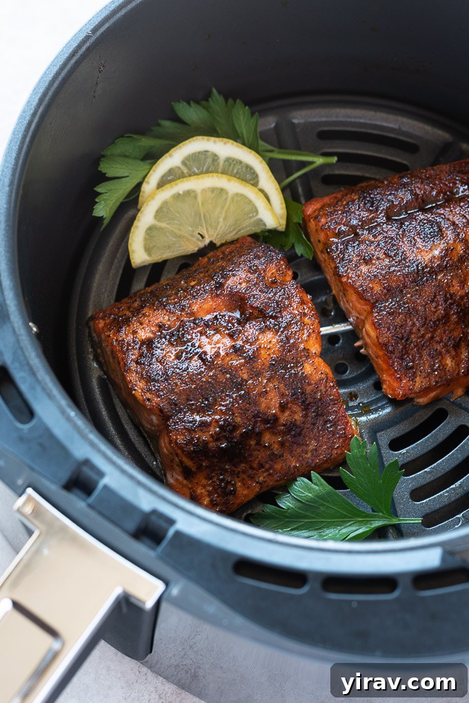 Effortless Air-Fried Salmon 3 Salmon in air fryer with lemon and parsley, highlighting its delicious texture