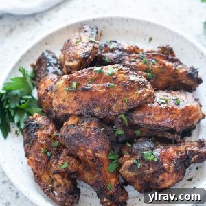 Air Fryer Wings: Crispy Perfection 9 Air fryer chicken wings piled on a plate
