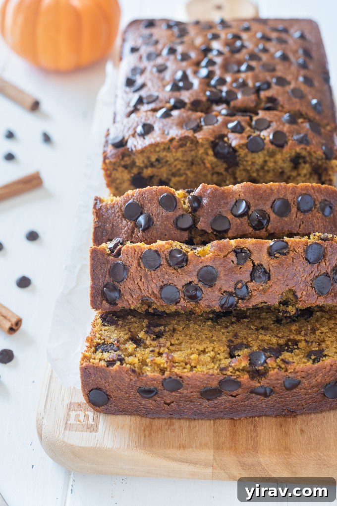 Thick, inviting slices of gluten-free pumpkin bread arranged on a cutting board, showcasing its rich color and tender crumb.