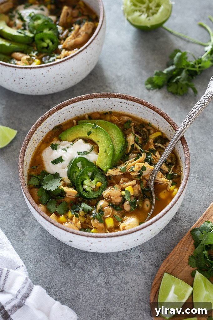 White bean chicken chili in a bowl with spoon nestled inside