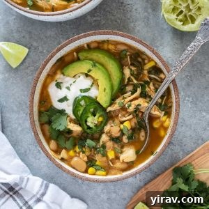 Bowl of instant pot white chicken chili with spoon digging in