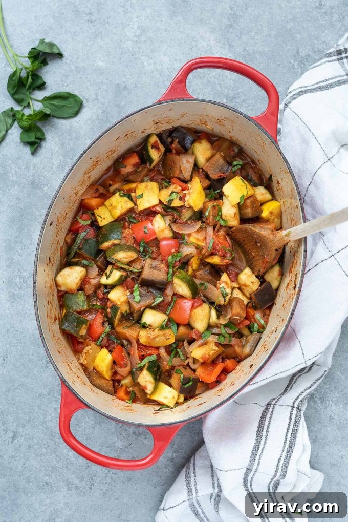 Effortless Ratatouille 2 Ratatouille simmering in a Dutch oven, garnished with fresh basil leaves