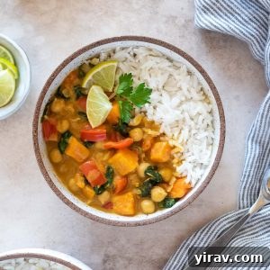 Instant pot sweet potato chickpea curry in a bowl with lime and cilantro