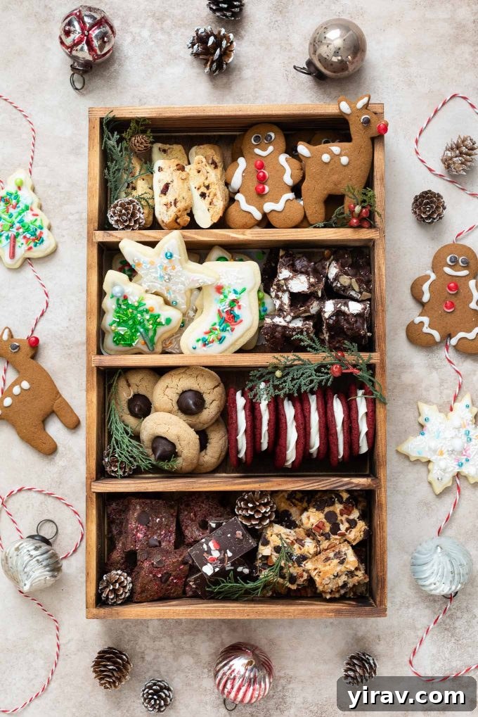 Festive Christmas cookie box adorned with twine, pine cones, and small ornament decorations, overflowing with assorted holiday cookies