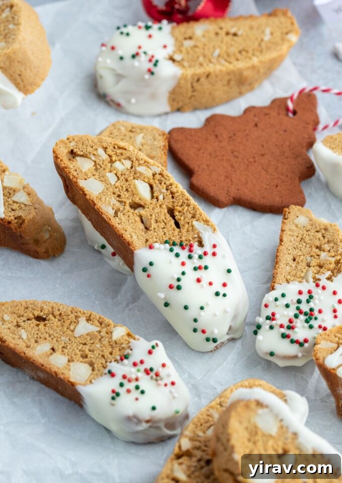 Gingerbread biscotti dipped in white chocolate with sprinkles
