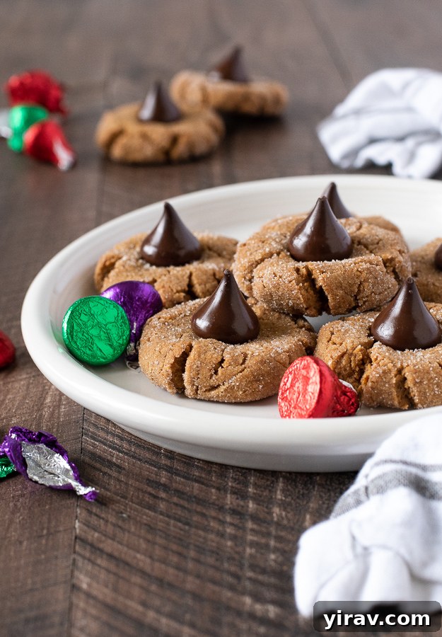 Gluten free peanut butter blossoms on white plate with kisses